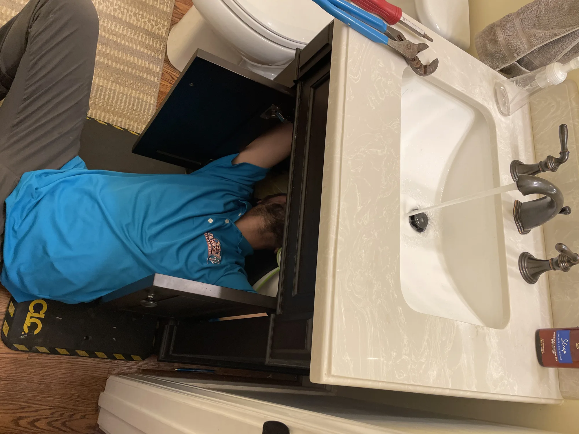 Leaking Faucet - Tech Repairing Bathroom Sink