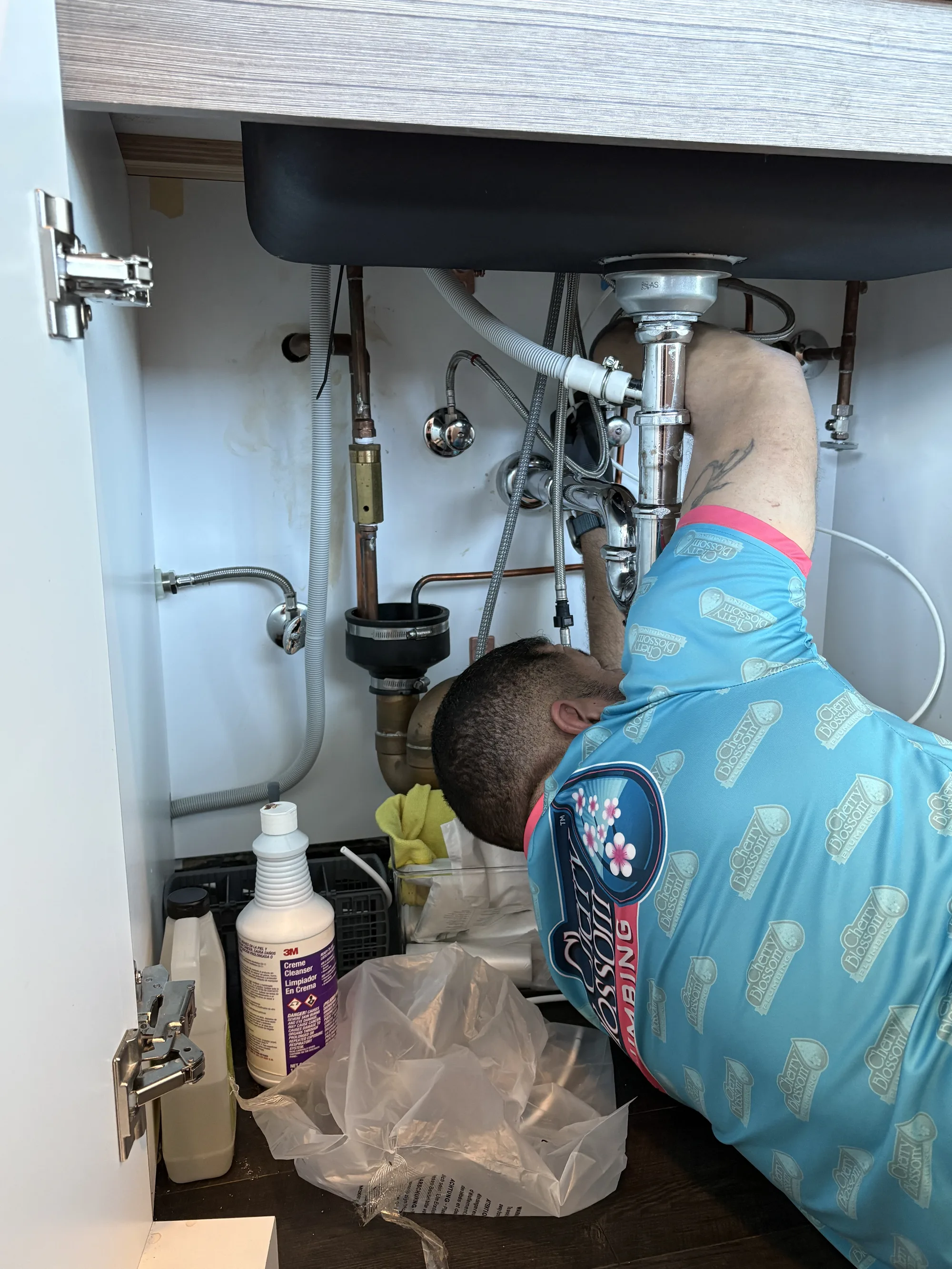 Leaking Faucet - Tech Working Under Kitchen Sink