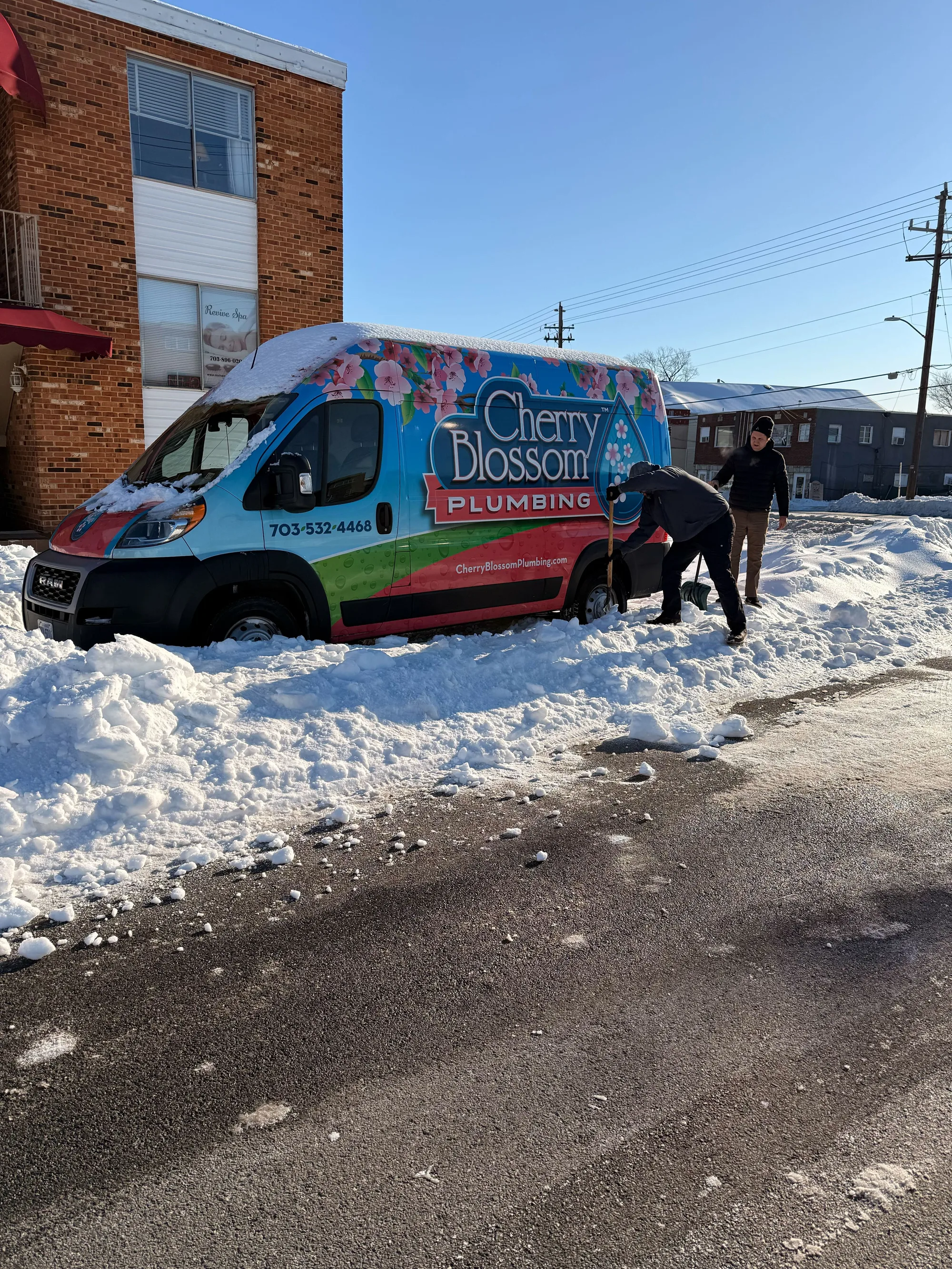 Techs Shoveling Van out of Snow 3