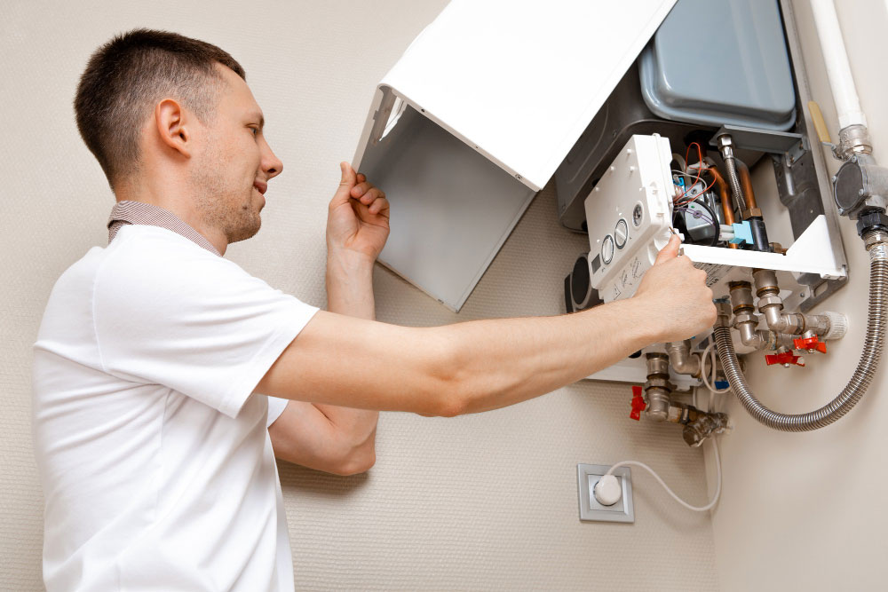plumber attaches trying fix problem with residential heating equipment repair gas boiler