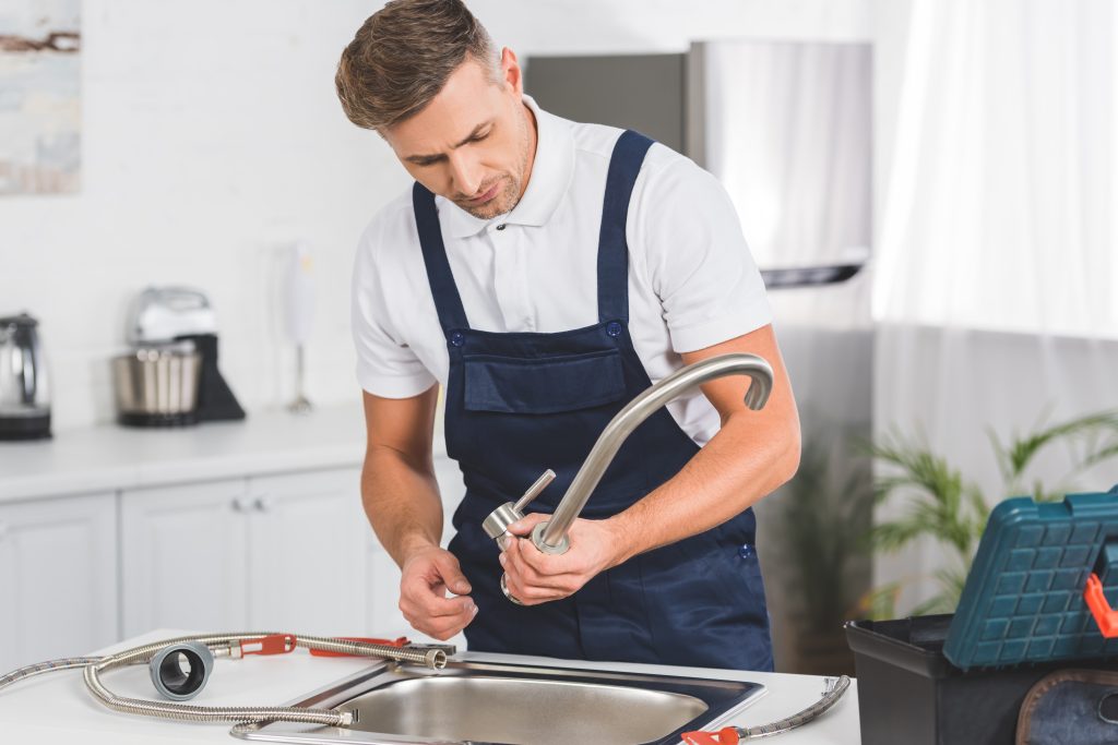 thoughtful adult repairman taking off kitchen fauc 2023 11 27 05 01 43 utc scaled